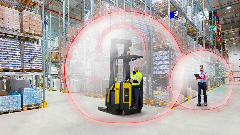 Yale reach truck with Yale Reliant operator assist system slowing as nears pedestrian. 