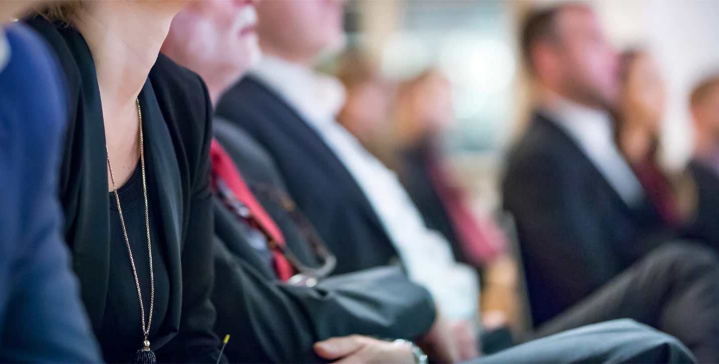 Row of executives sitting together.