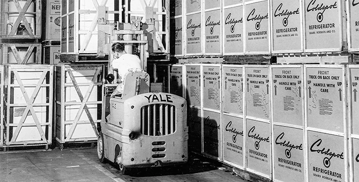1950’s Yale & Towne lift truck lifting pallet in warehouse.