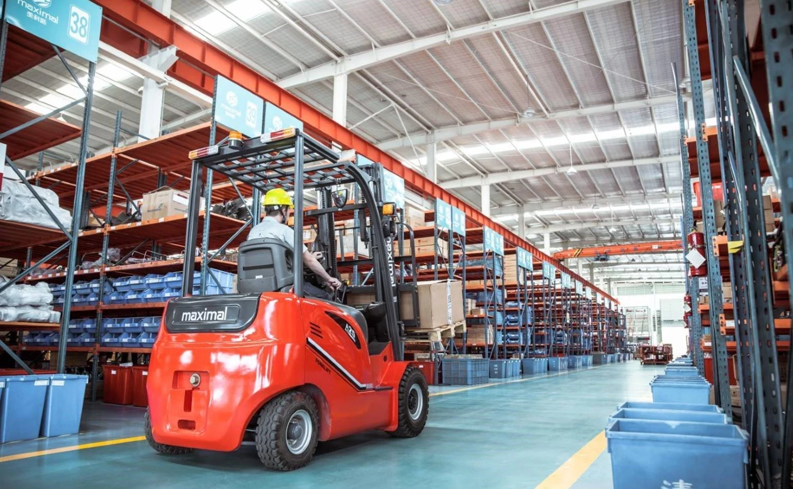 "Maximal lift truck driving in warehouse."