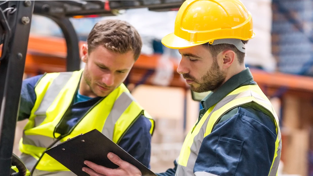 Workers checking over checklist.